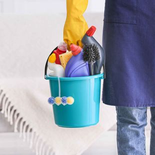 Best commercial cleaning services in Boone NC employee is holding a blue bucket filled with cleaning supplies.