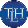 Blue circular logo with silver letters 