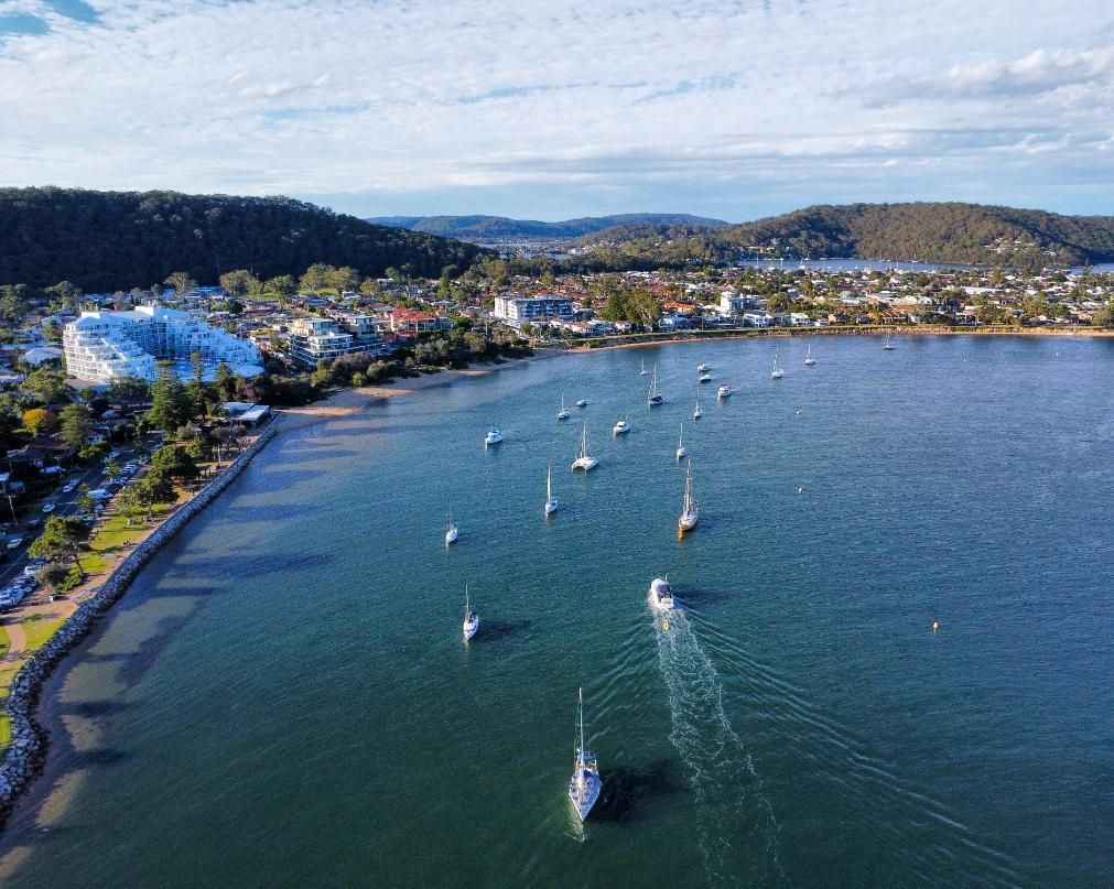 An Aerial View Of A Body Of Water With Boats In It And A City In The Background — Economy Waste Group | Skip Bins Central Coast In Ettalong, NSW