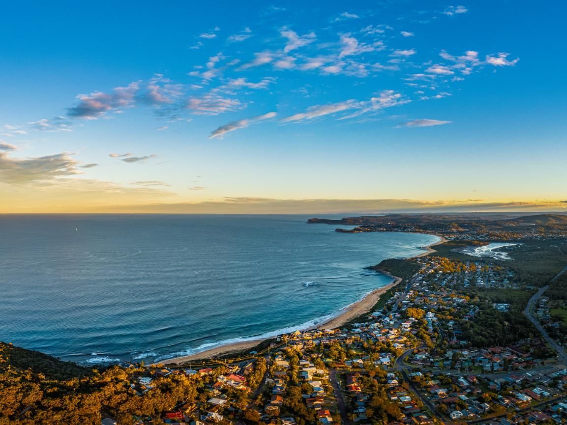 An Aerial View Of A Beach With A City In The Background — Economy Waste Group | Skip Bins Central Coast In Forresters Beach, NSW