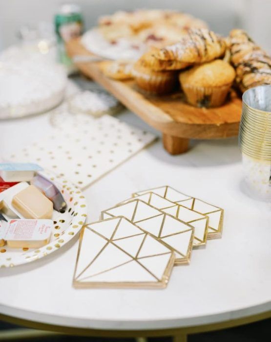 A table with a plate of food and coasters on it