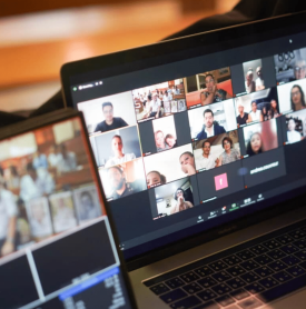 A laptop with a bunch of people on the screen