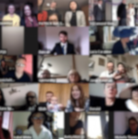 A group of people are sitting in front of a computer screen