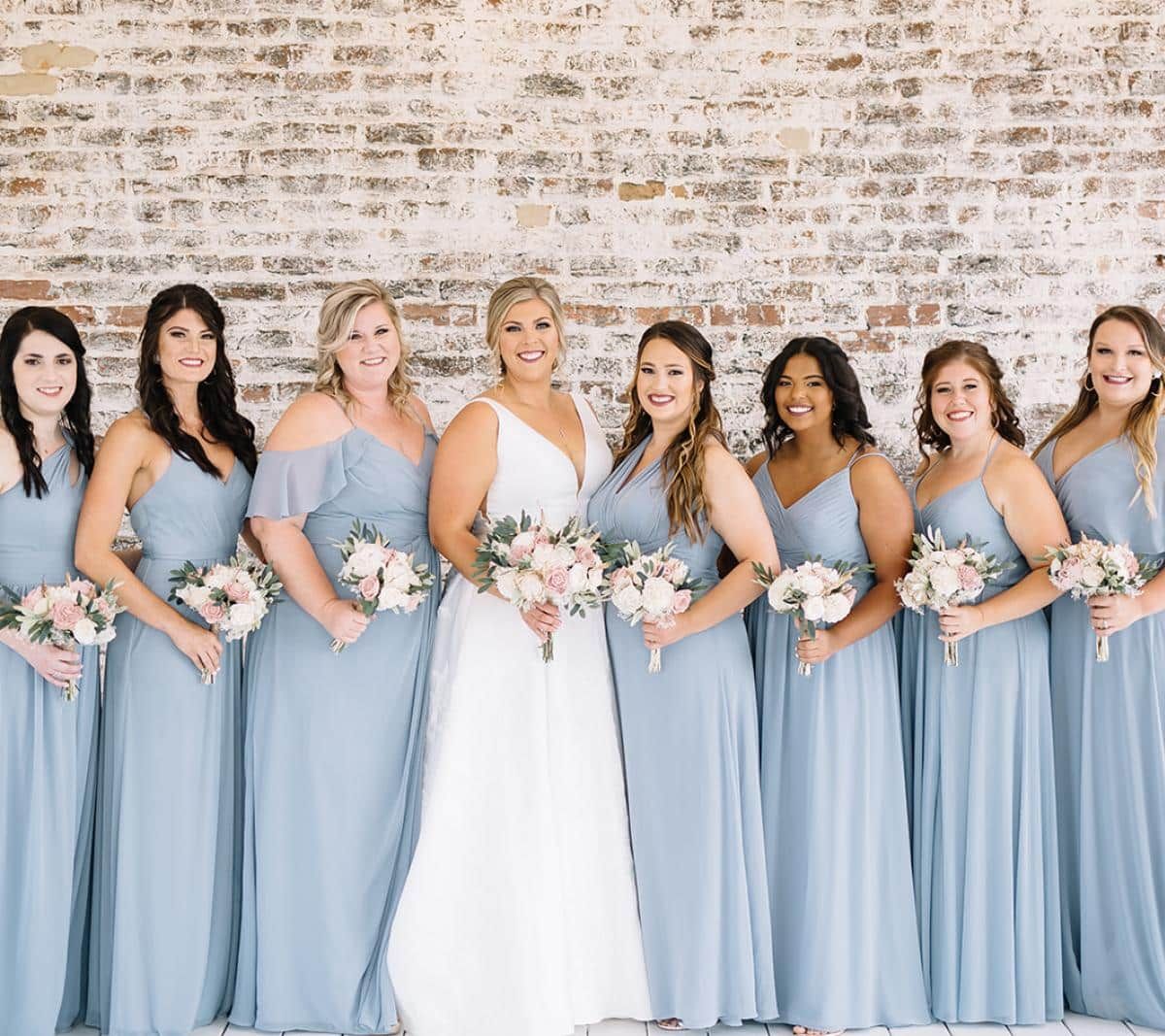 Wedding bridal party take a beautiful portrait at The Cowan Historic Mill's Upper Patio Terrace ceremony location. Acworth