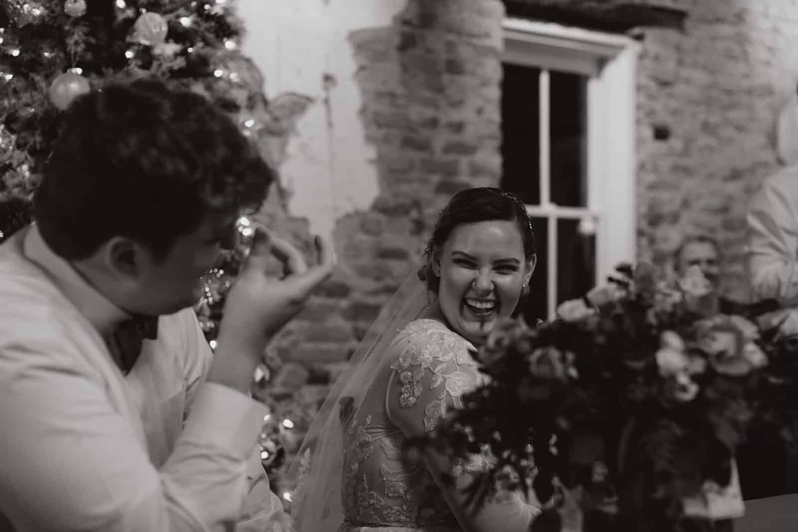 Christmas wedding of Bride and Groom laughing. 
