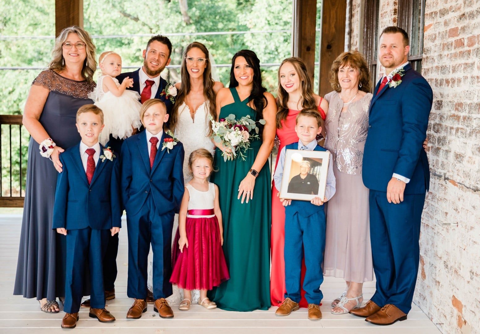 Family taking a wedding portrait on The Cowan Historic Mill's Upper Patio Terrace in Metro-Atlanta's Acworth, GA 