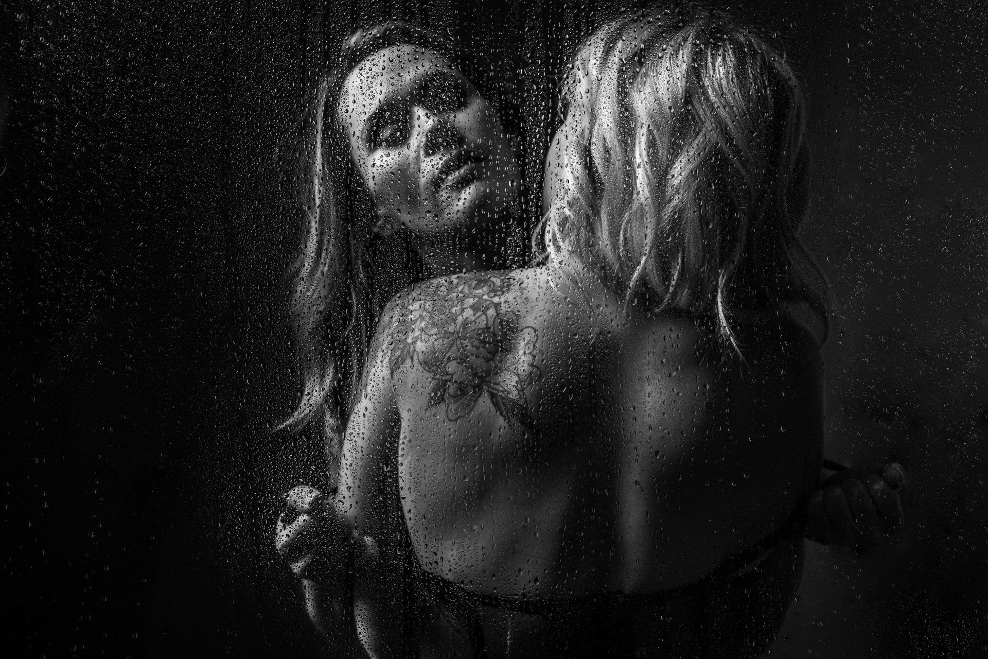 A person standing under a stream of water in the shower, enjoying the refreshing sensation.