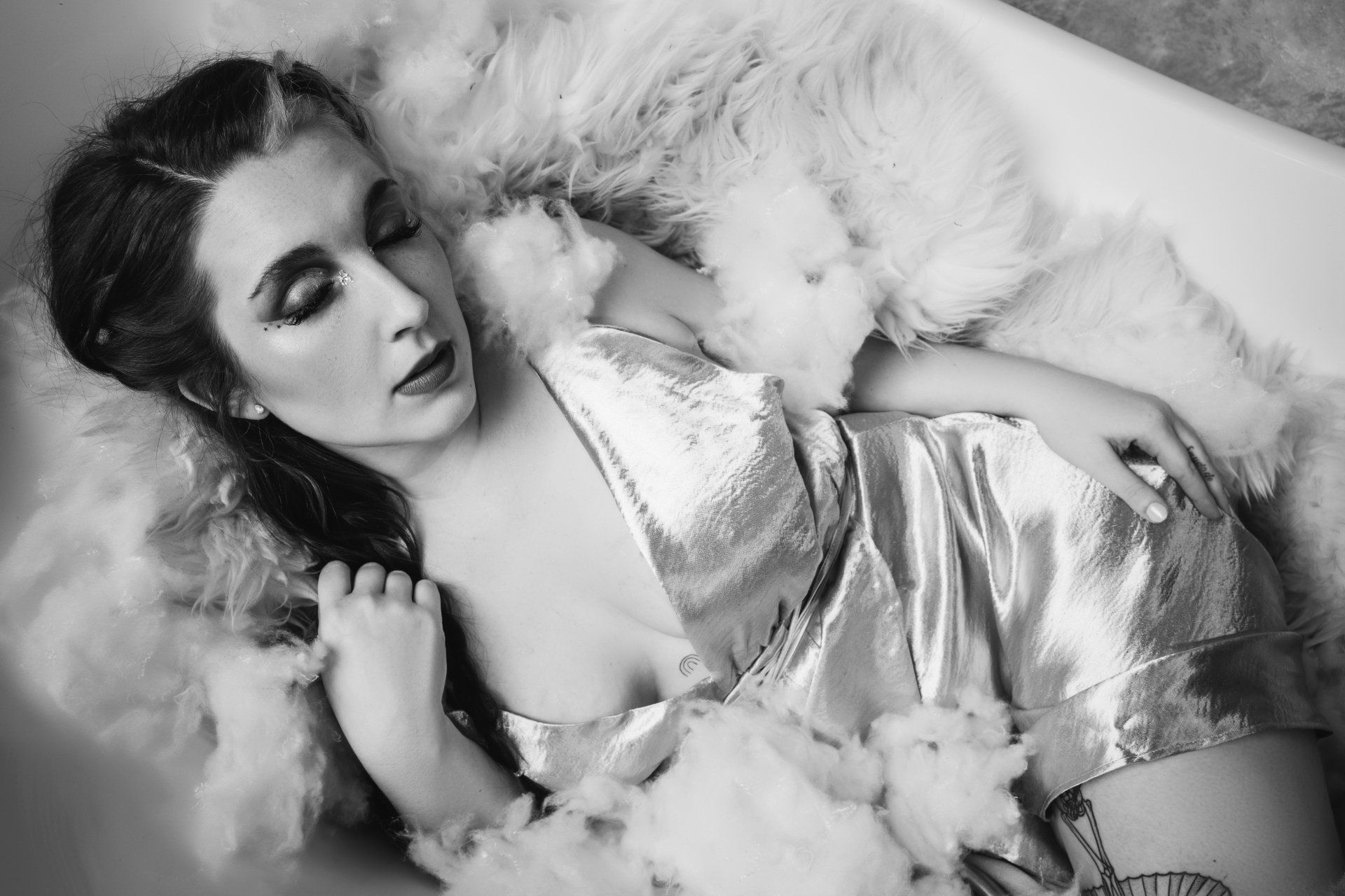 A woman posing on a sofa for boudoir photography.