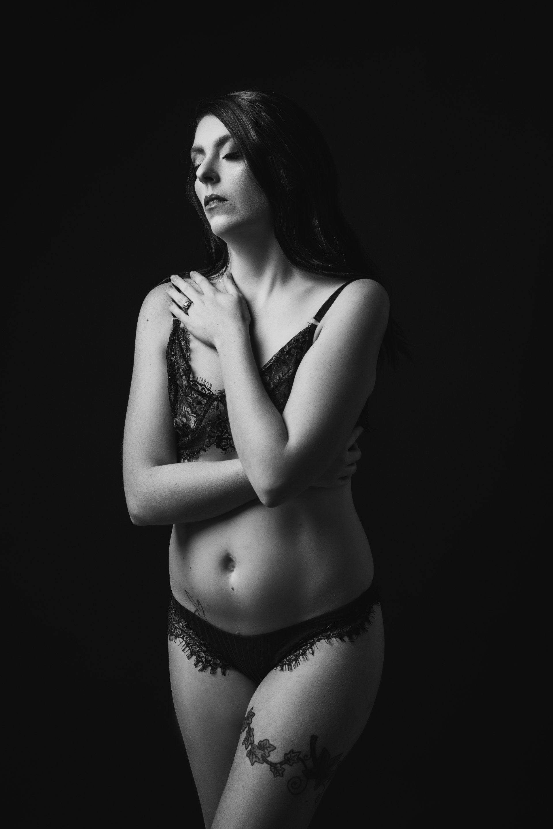 boudoir portrait of woman in front of backdrop