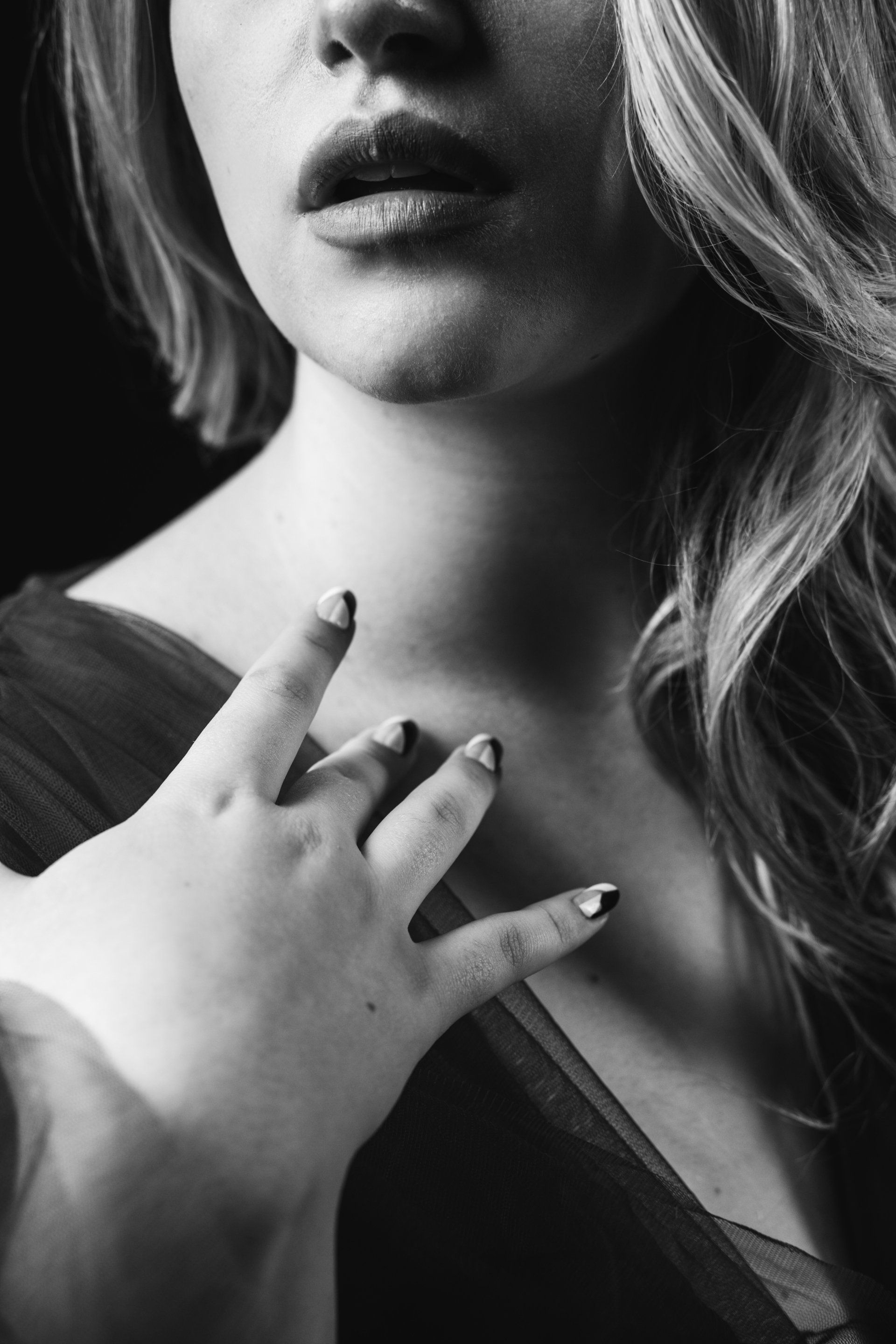 boudoir detail shot of lips and hand