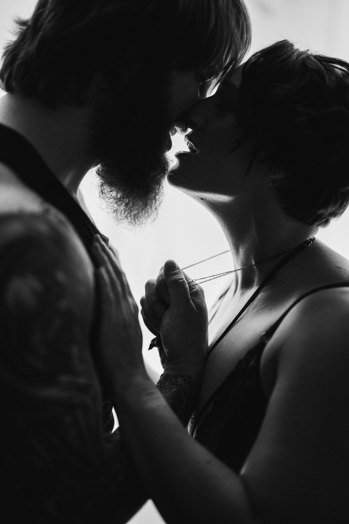 A man and woman embrace in a kiss.
