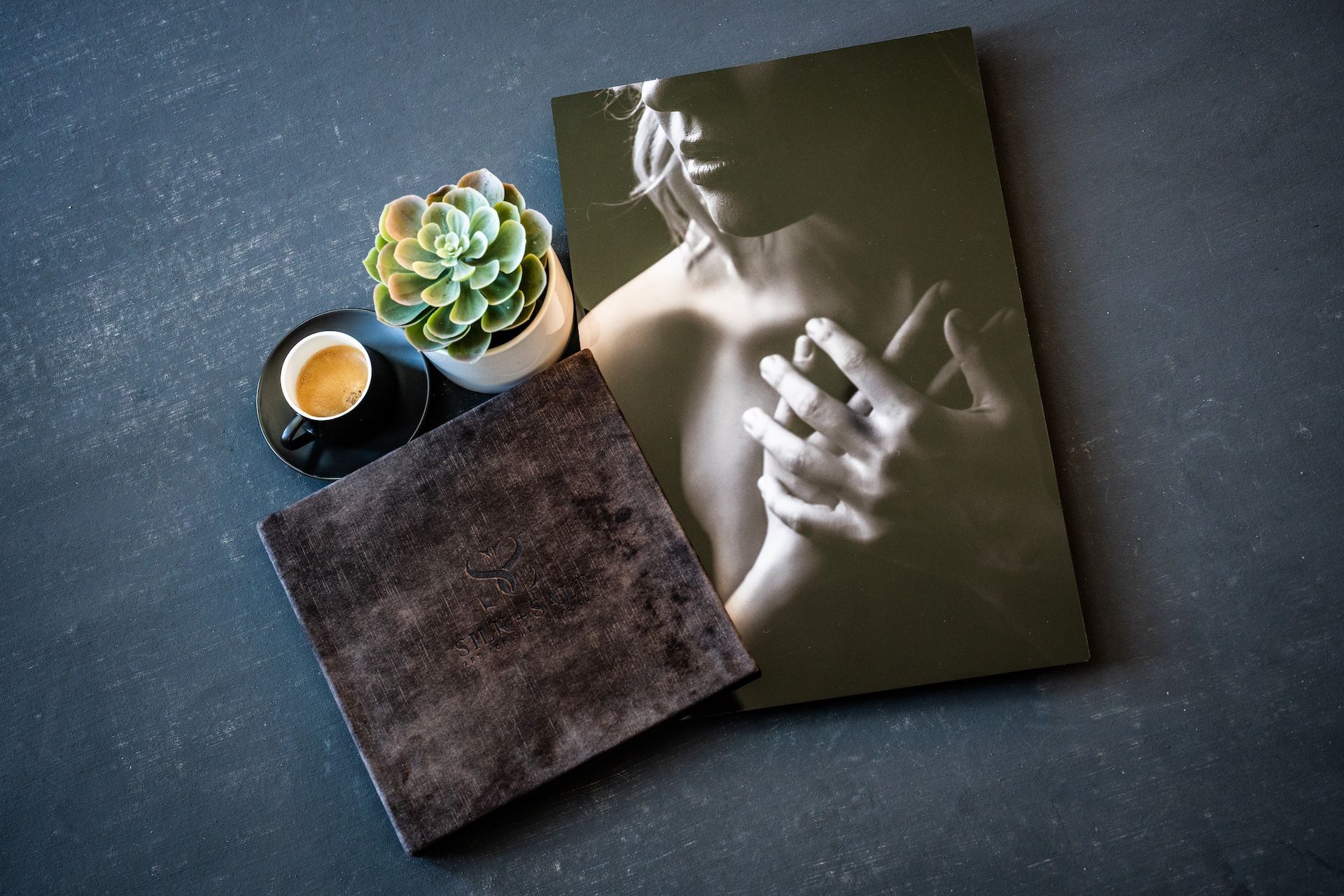 A book featuring a photograph of a woman's hand resting on its cover, highlighting the connection between literature and personal touch.