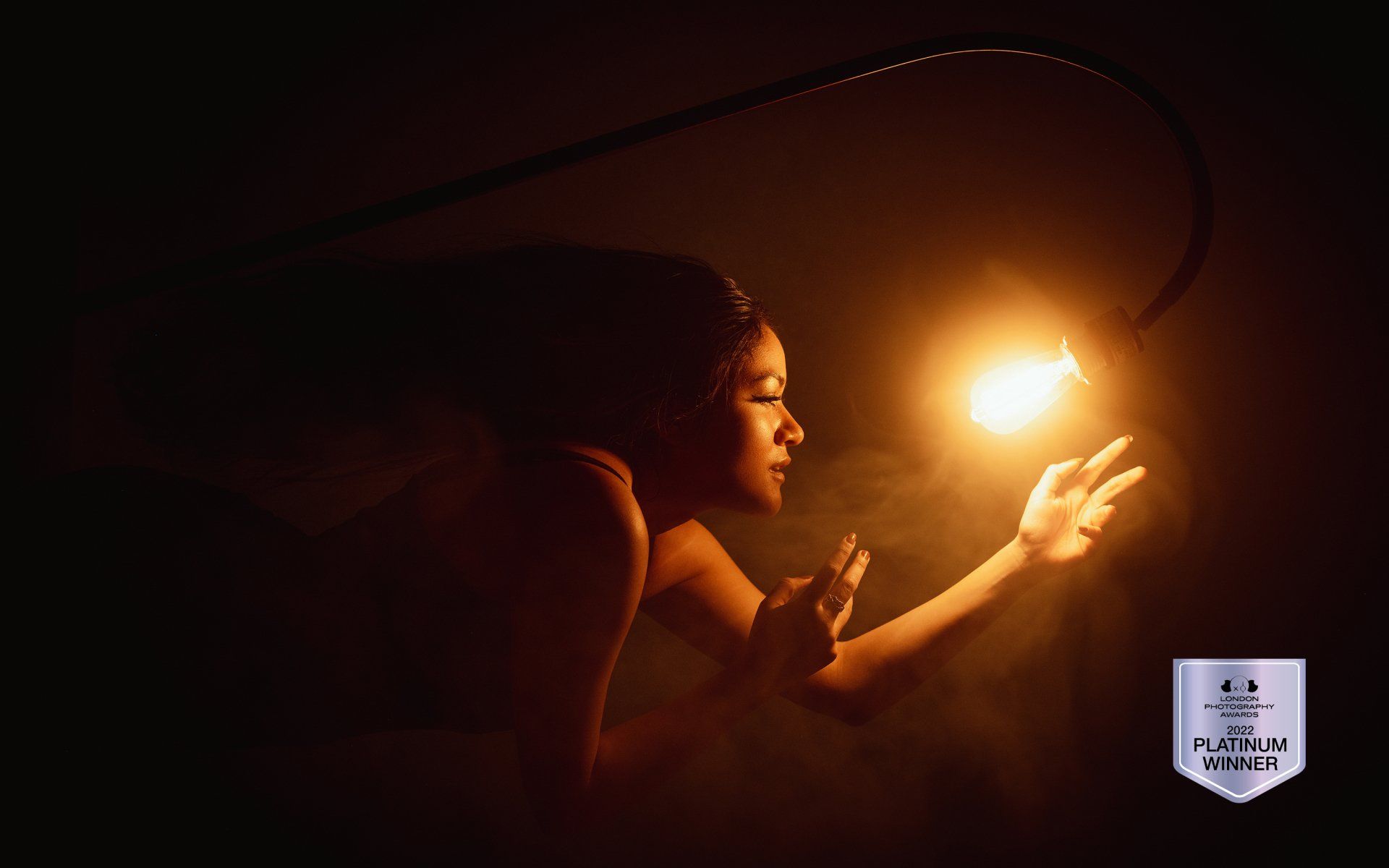 creative photography utah portrait of a woman reaching out for a lightbulb