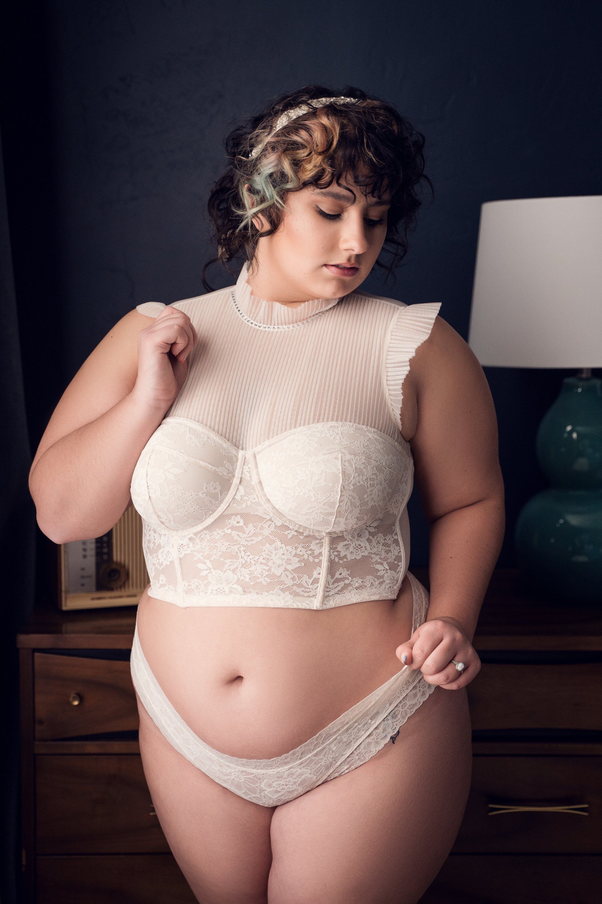 photo of a woman in curly hair in sexy clothes