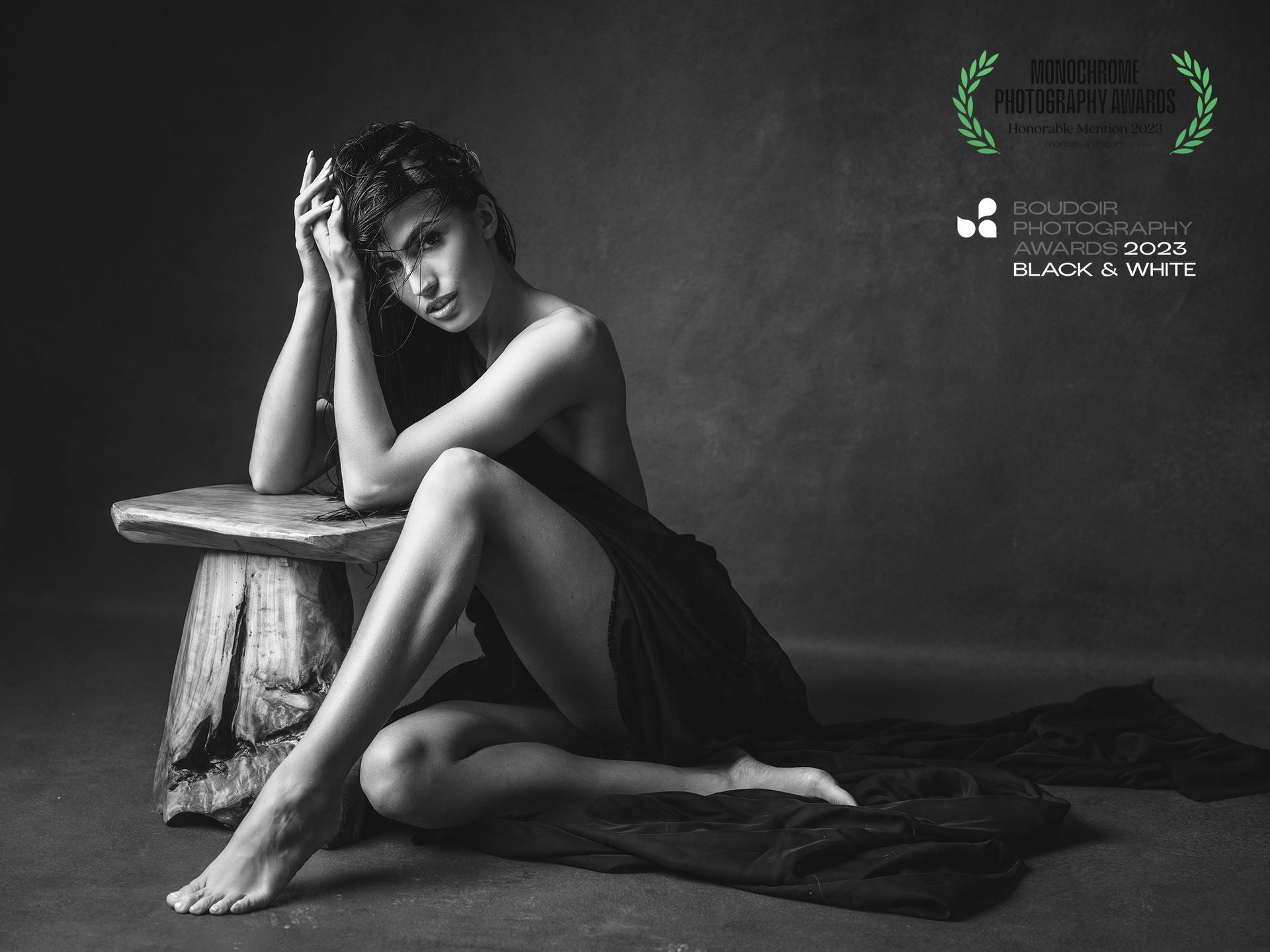 black and white photo of a woman sitting on the floor