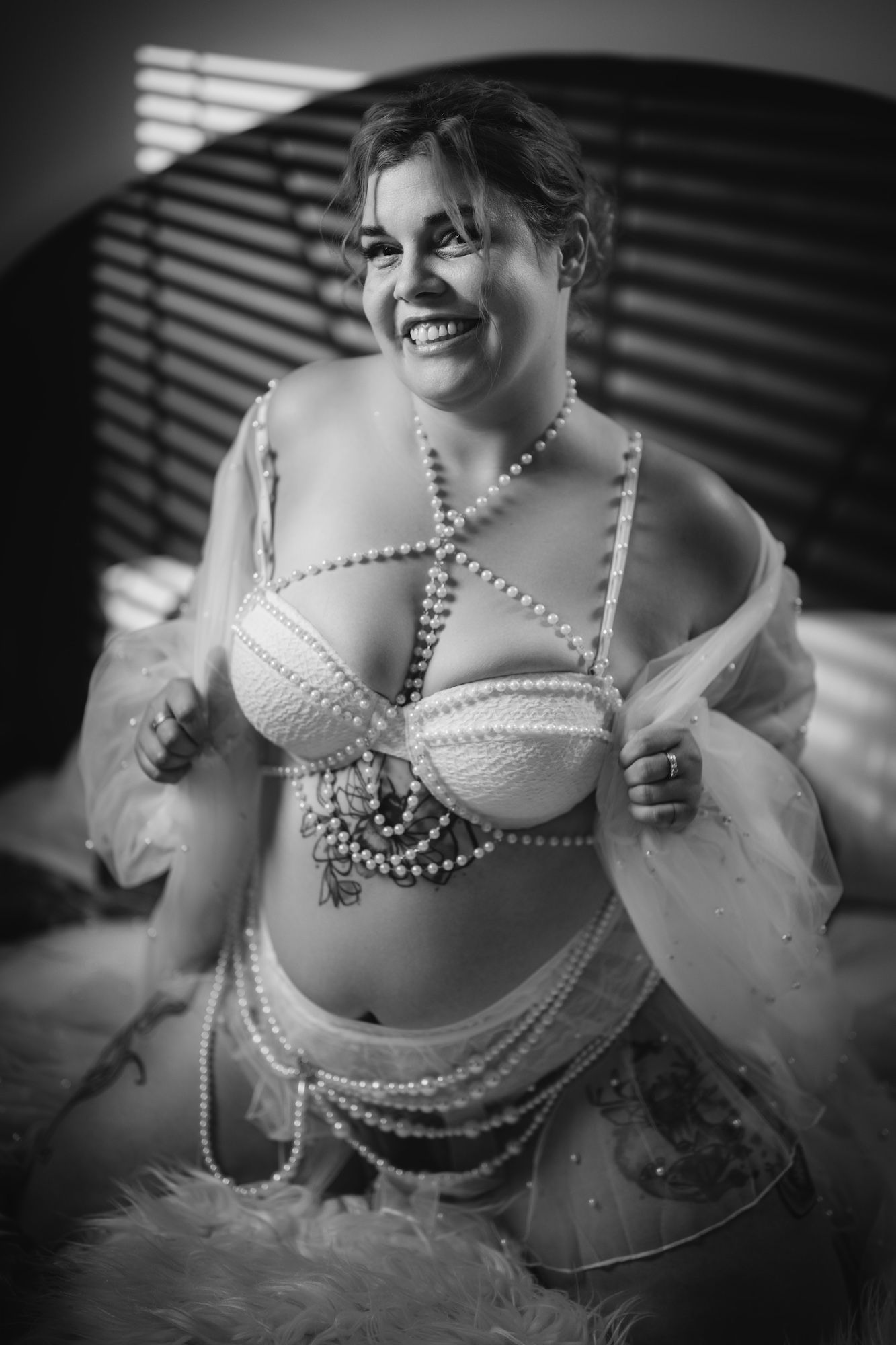 plus size woman in a pink hair wearing lingerie in black
