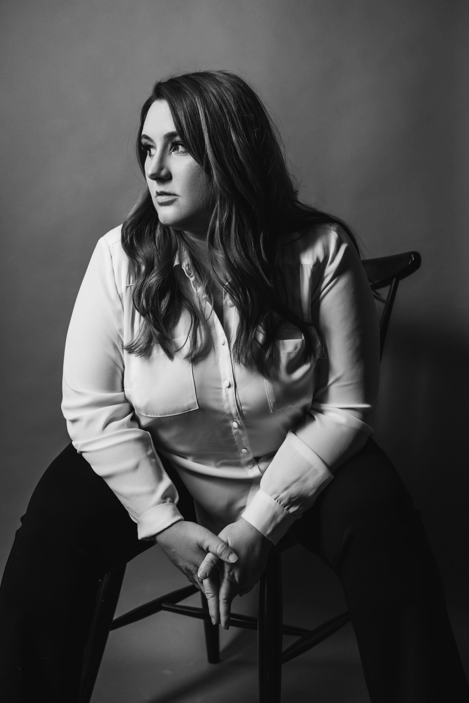 woman sitting in chair looking to the right
