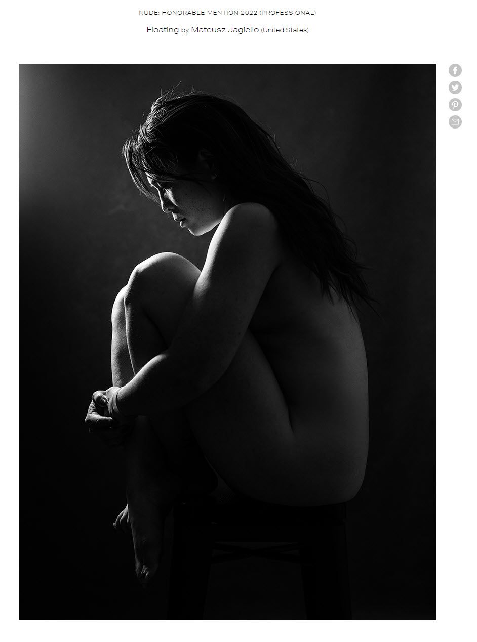 woman sitting on a stool holding her knees