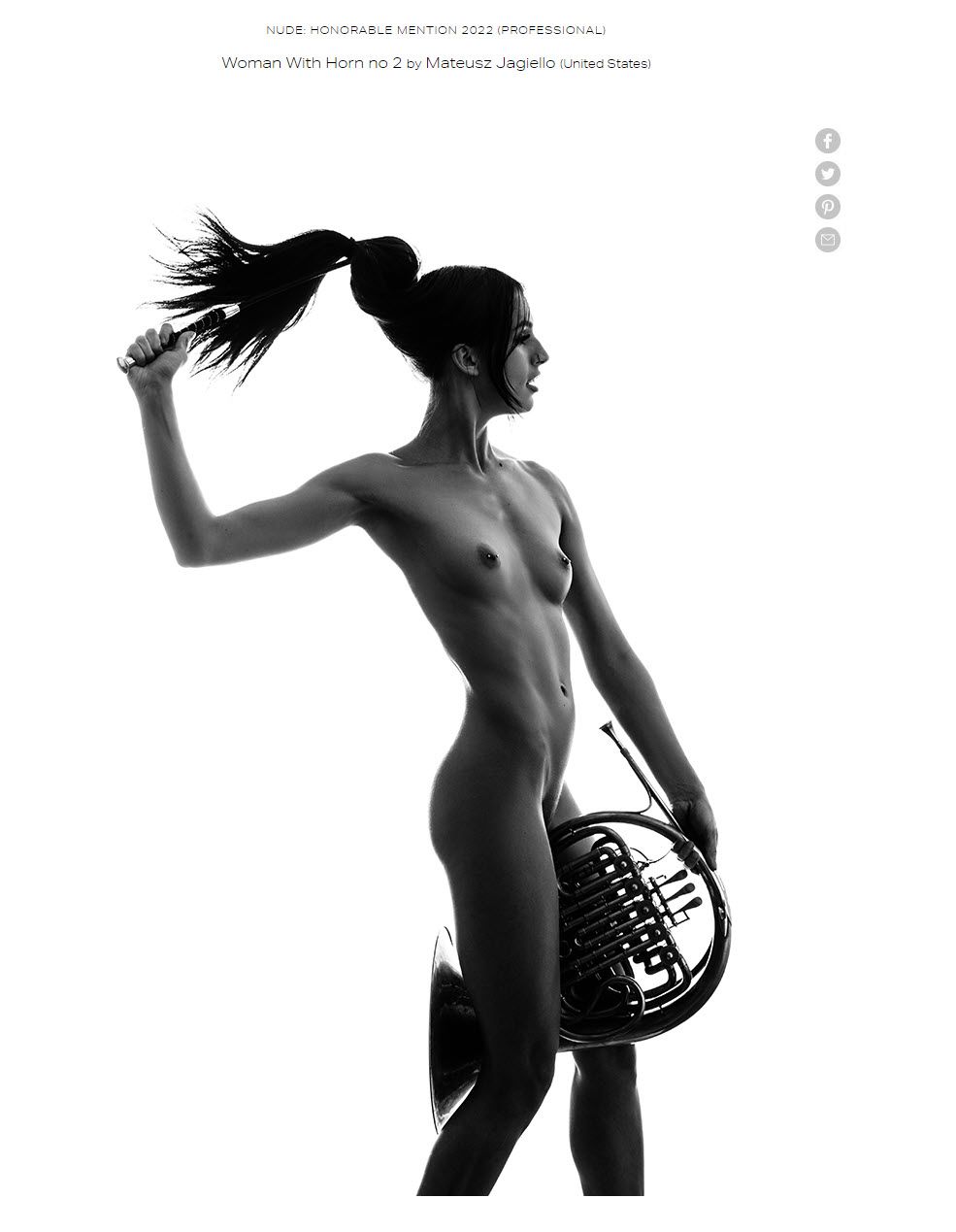 woman holding a french horn and crop