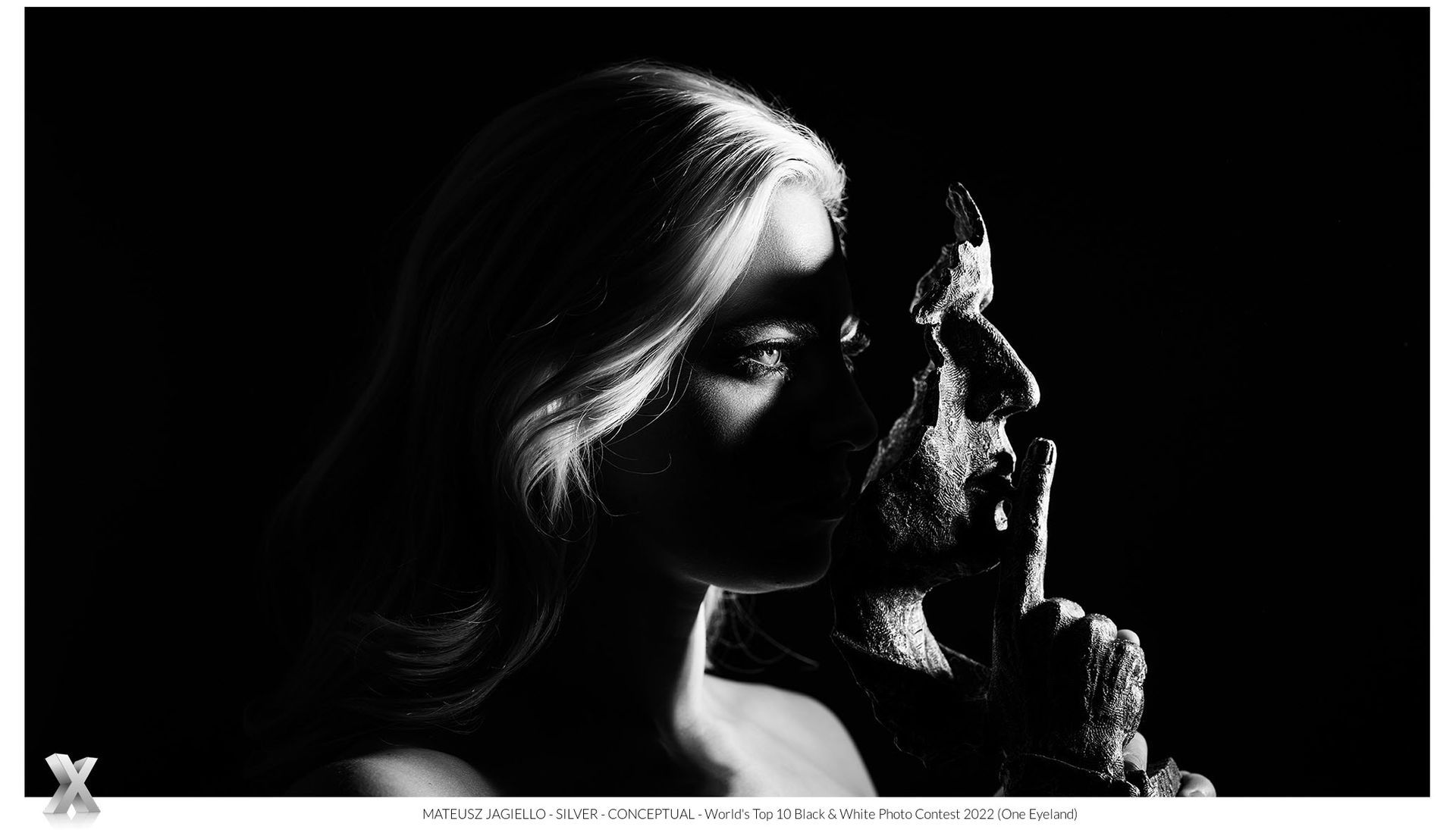 woman holding a mask in front of her face