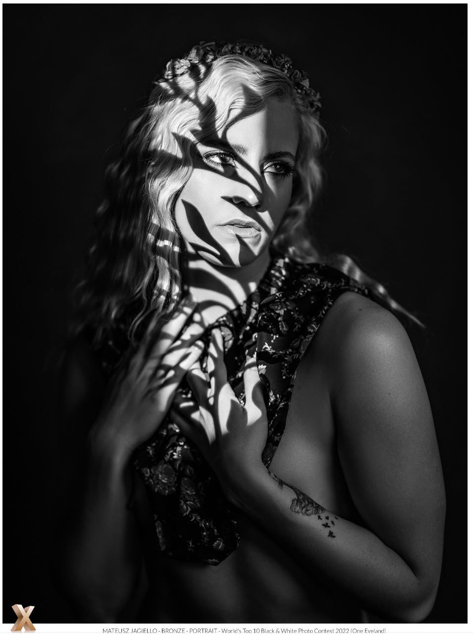 woman with a shadow of flowers on her face