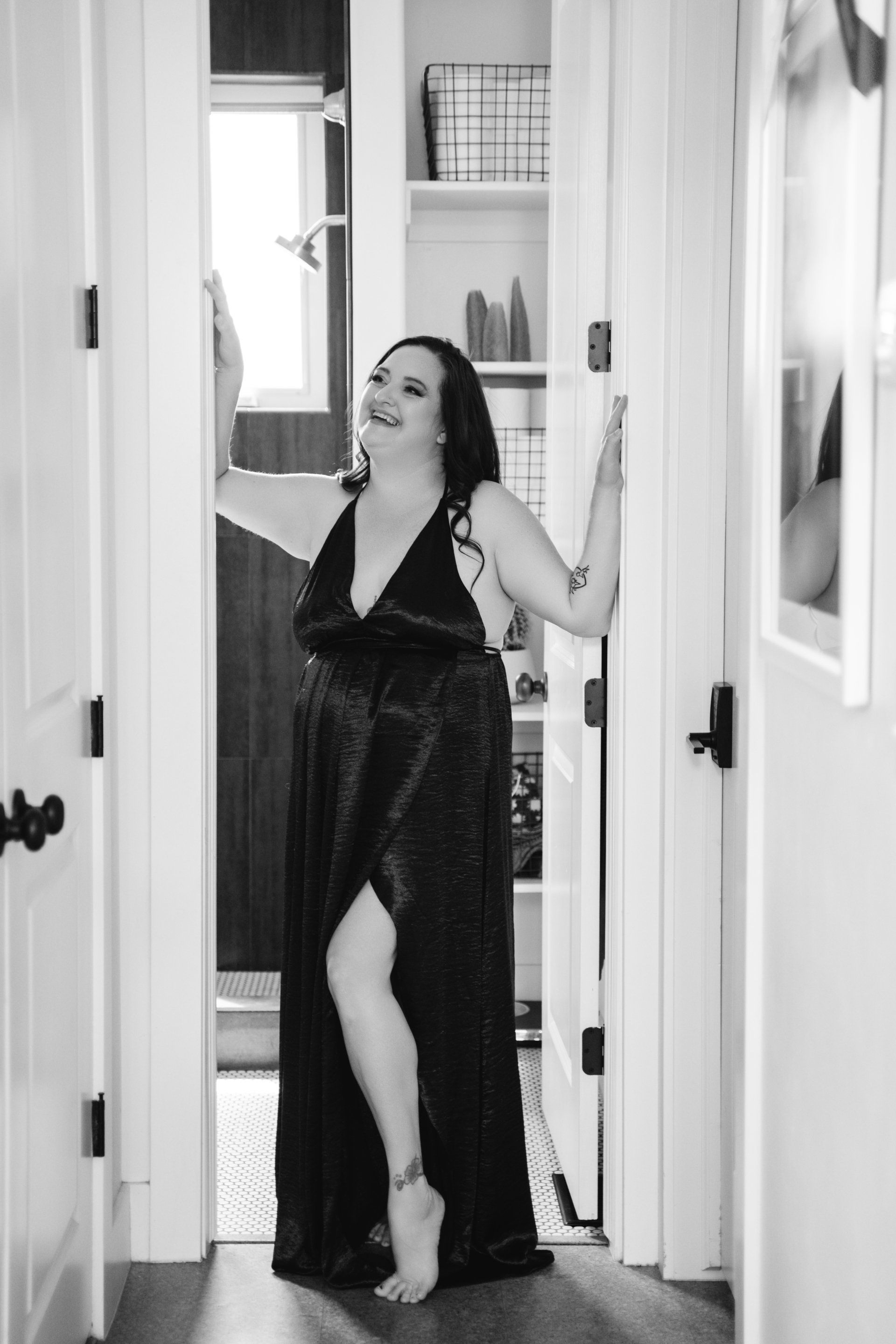 woman in gown standing in doorway and smiling