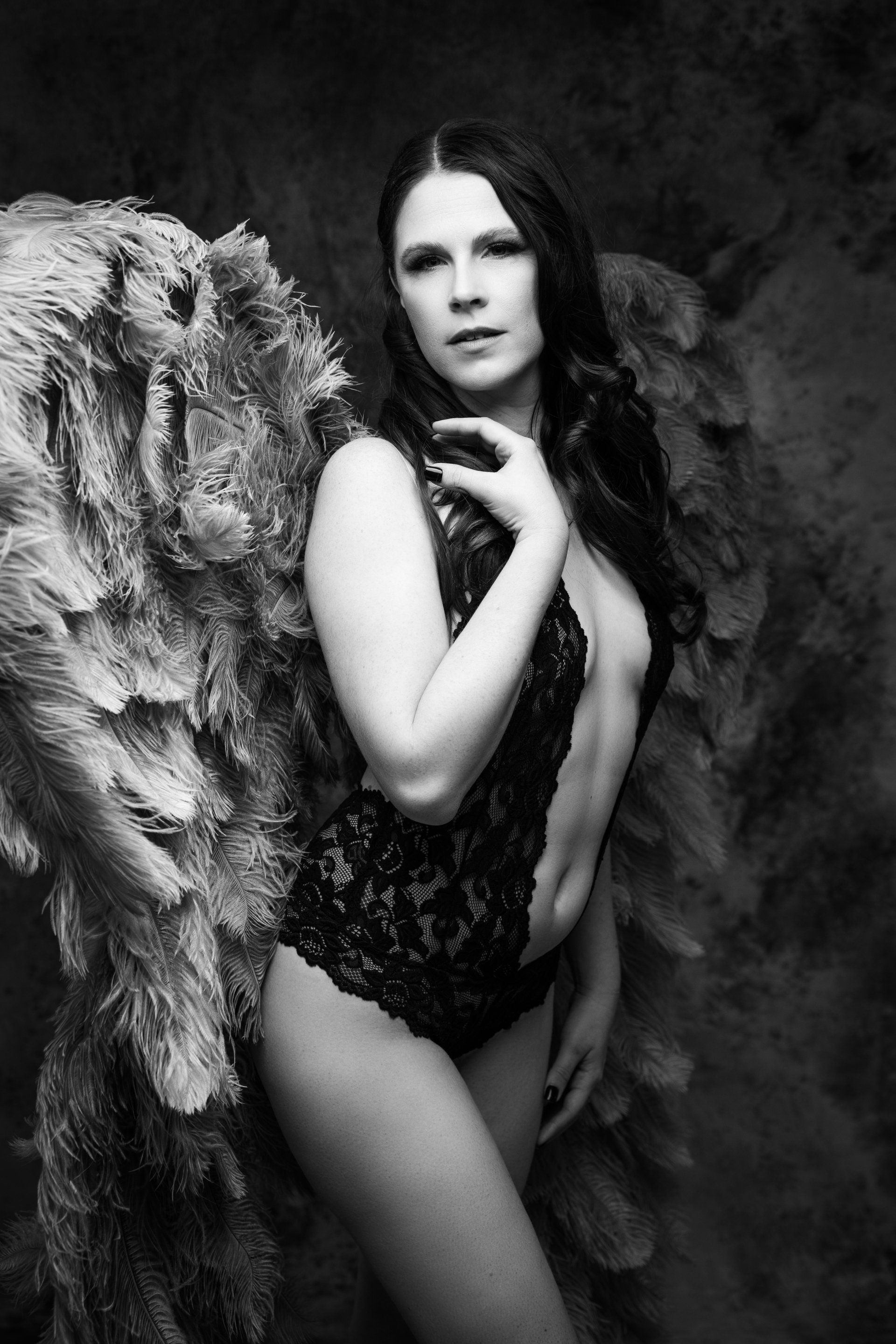 woman in angel wings and black boudoir lingerie