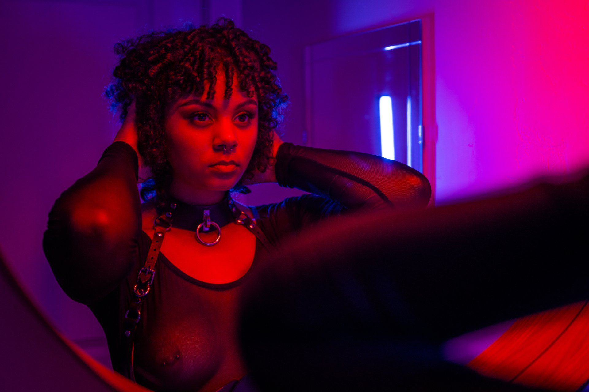 neon portrait of a young woman looking in the mirror