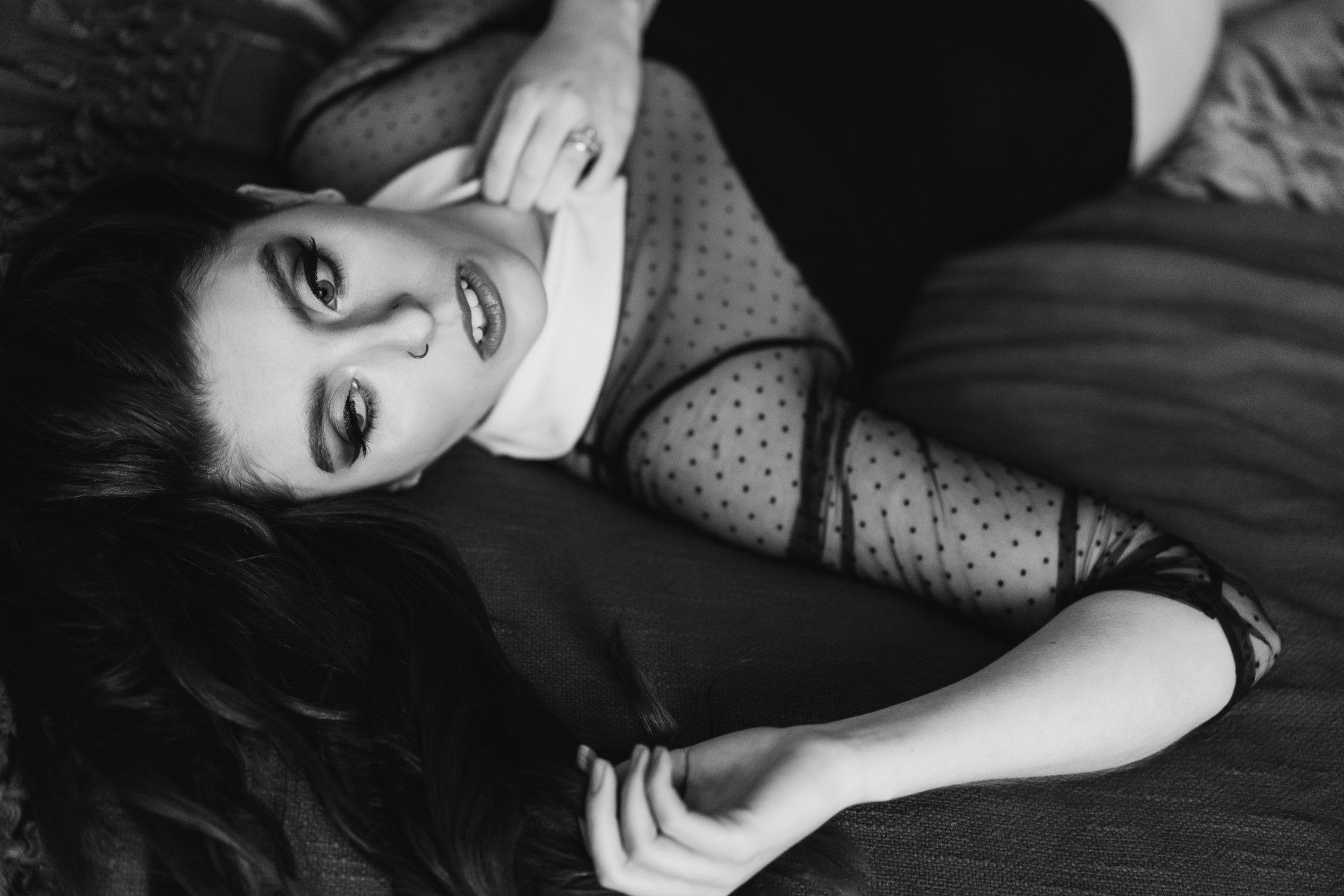 black and white boudoir image of woman on bed