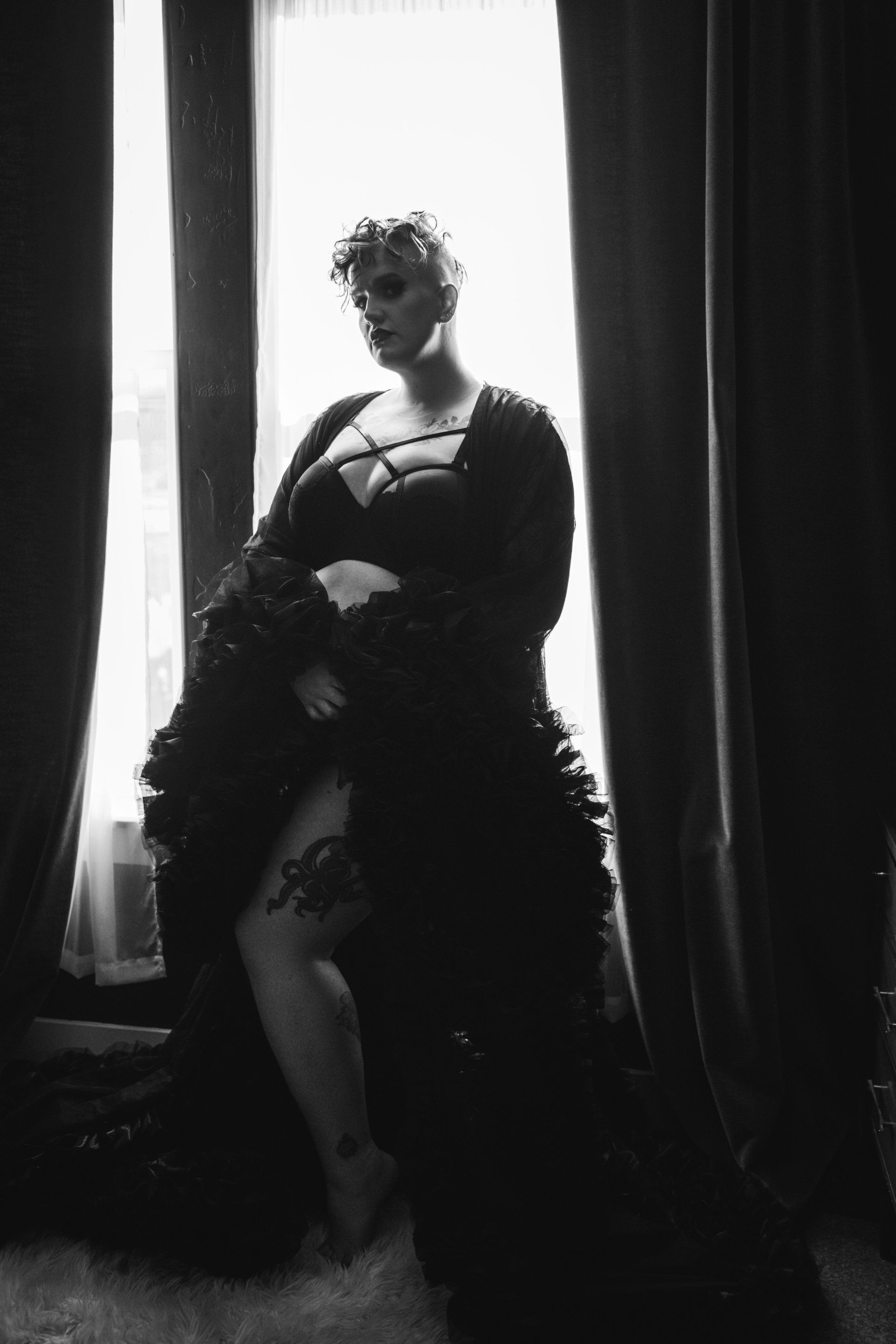 woman wearing murder robe in front of window