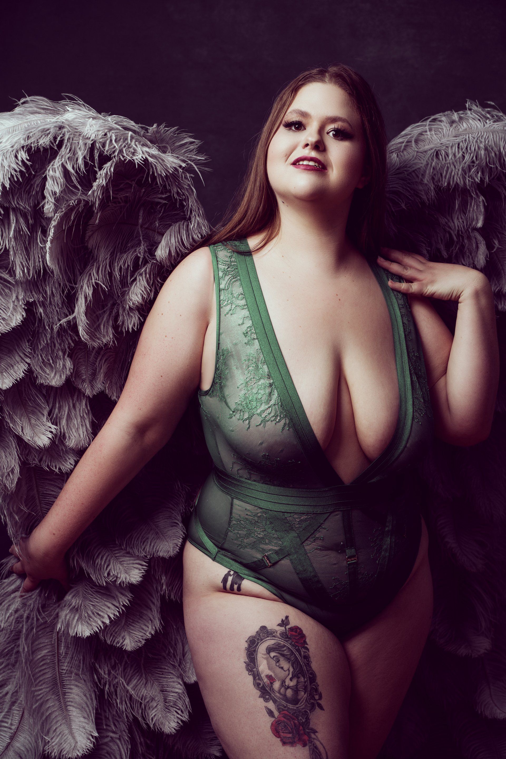 woman in angel wings and green lingerie