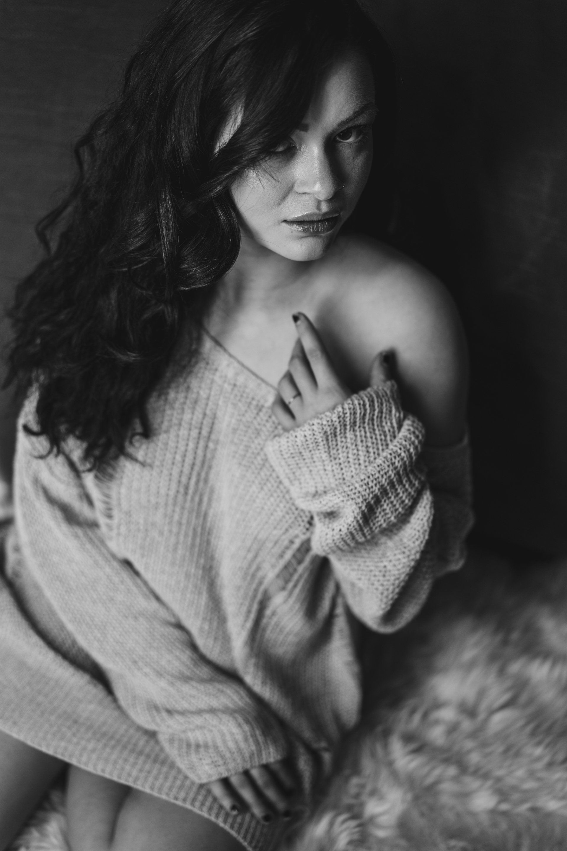 woman sitting on floor wearing sweater