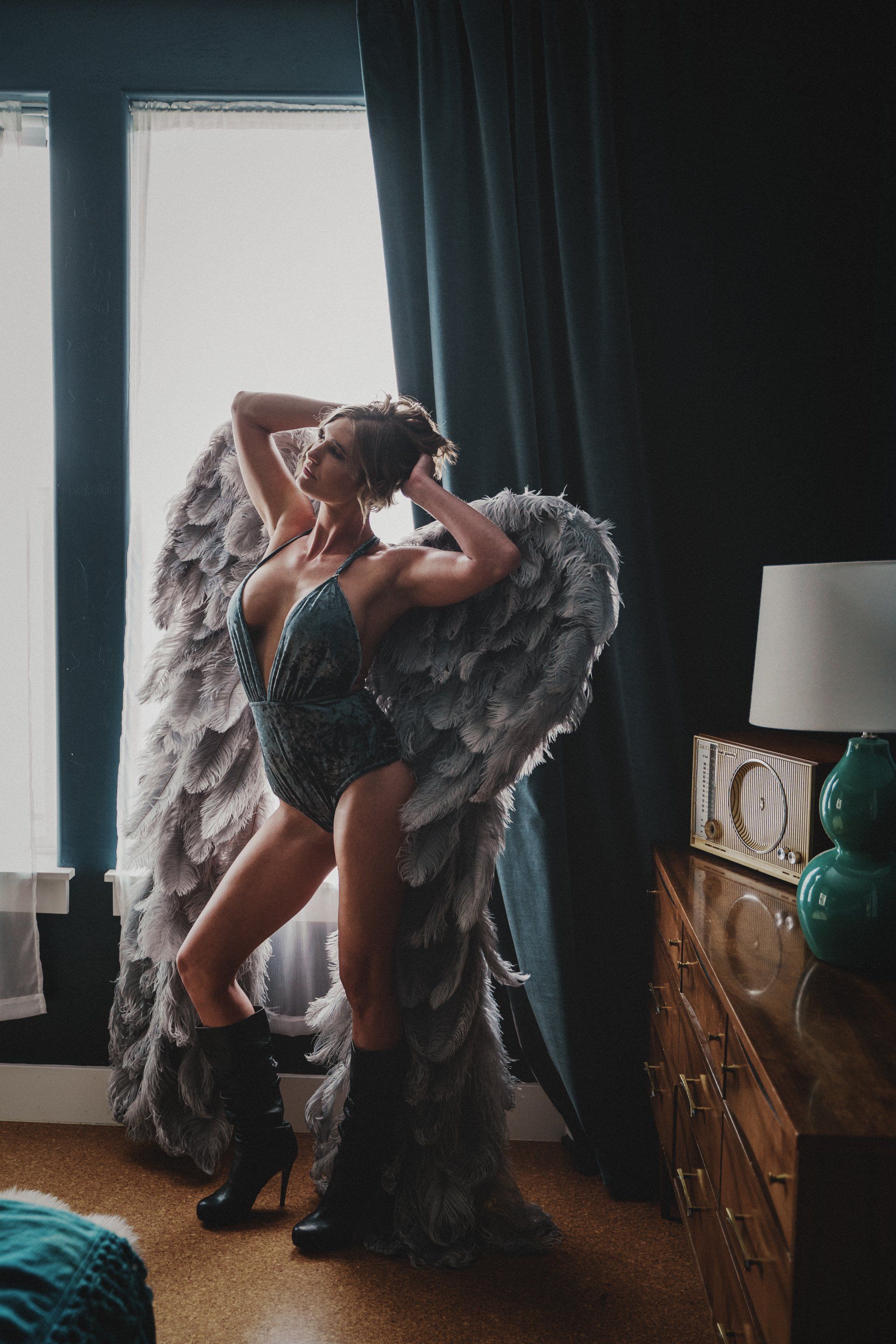 woman wearing wings in a wooden cabinet