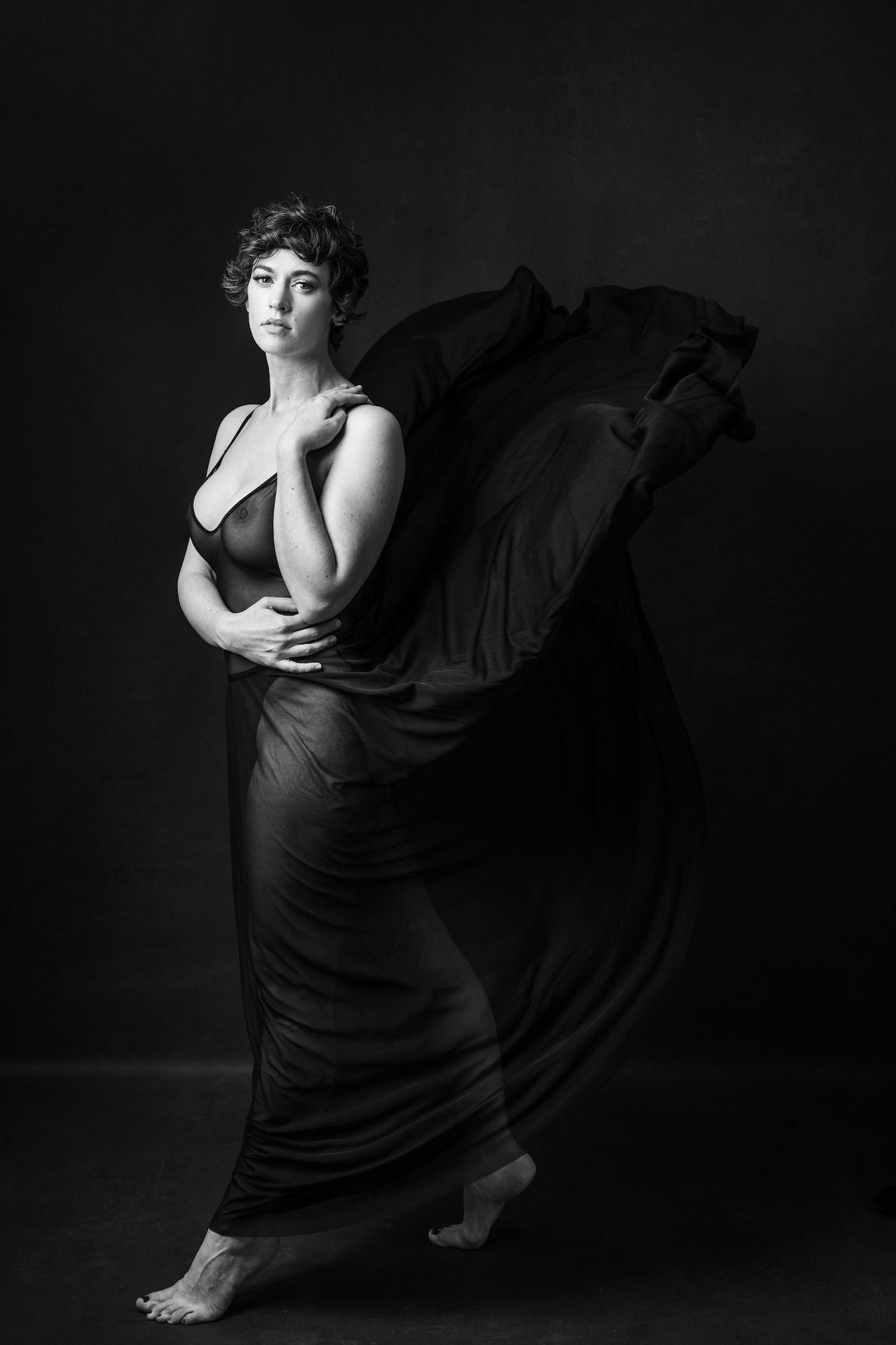 A woman in a dress looking at the camera.