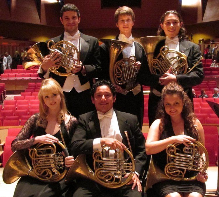  Band members smiling for a group picture.