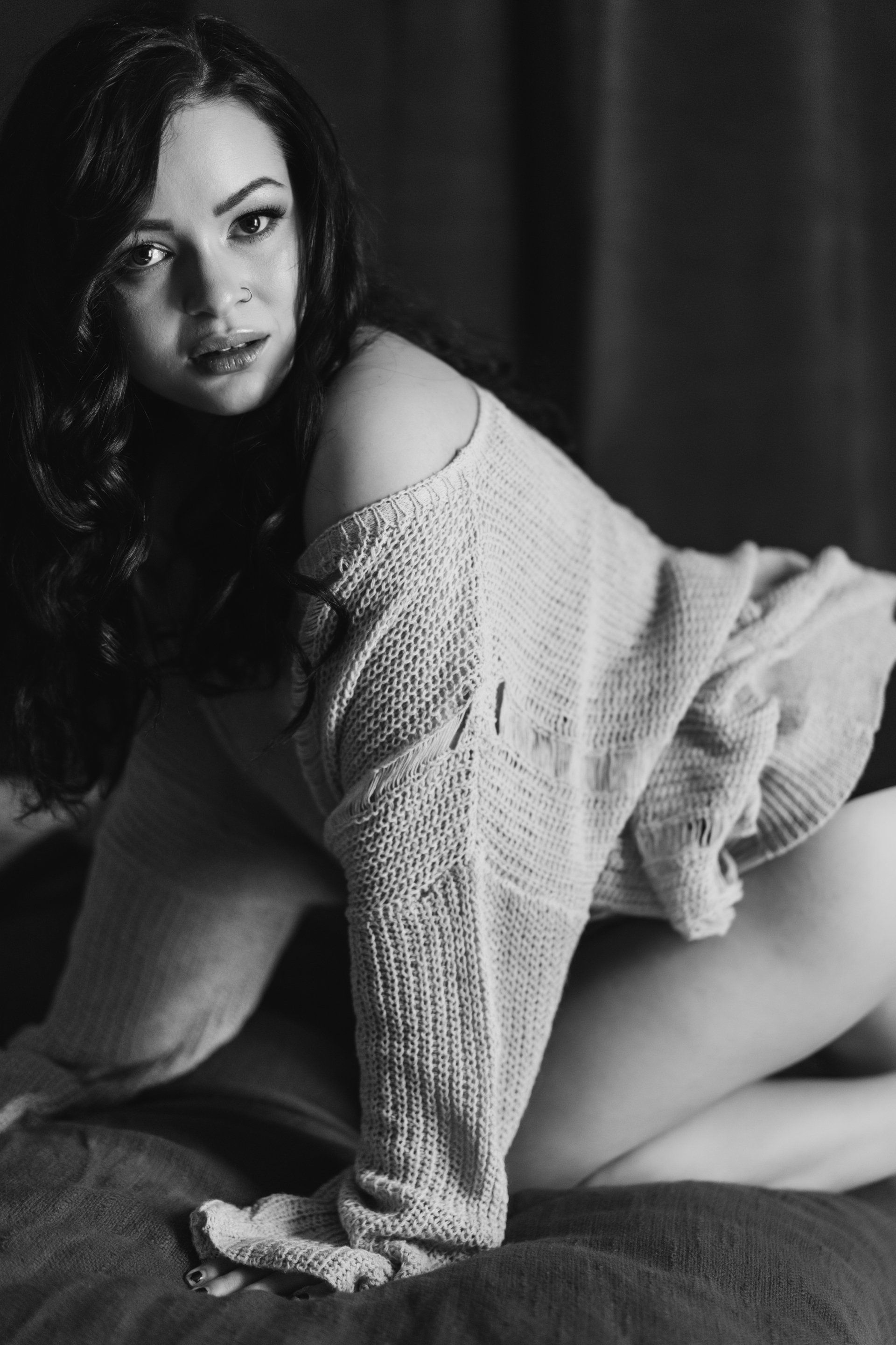woman looking at camera wearing sweater sexy boudoir