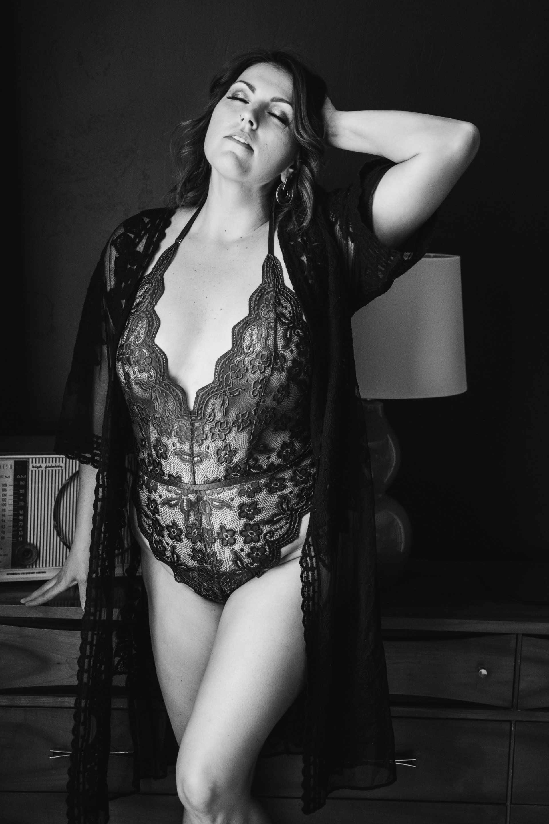 boudoir image of woman in front of dresser in lingerie