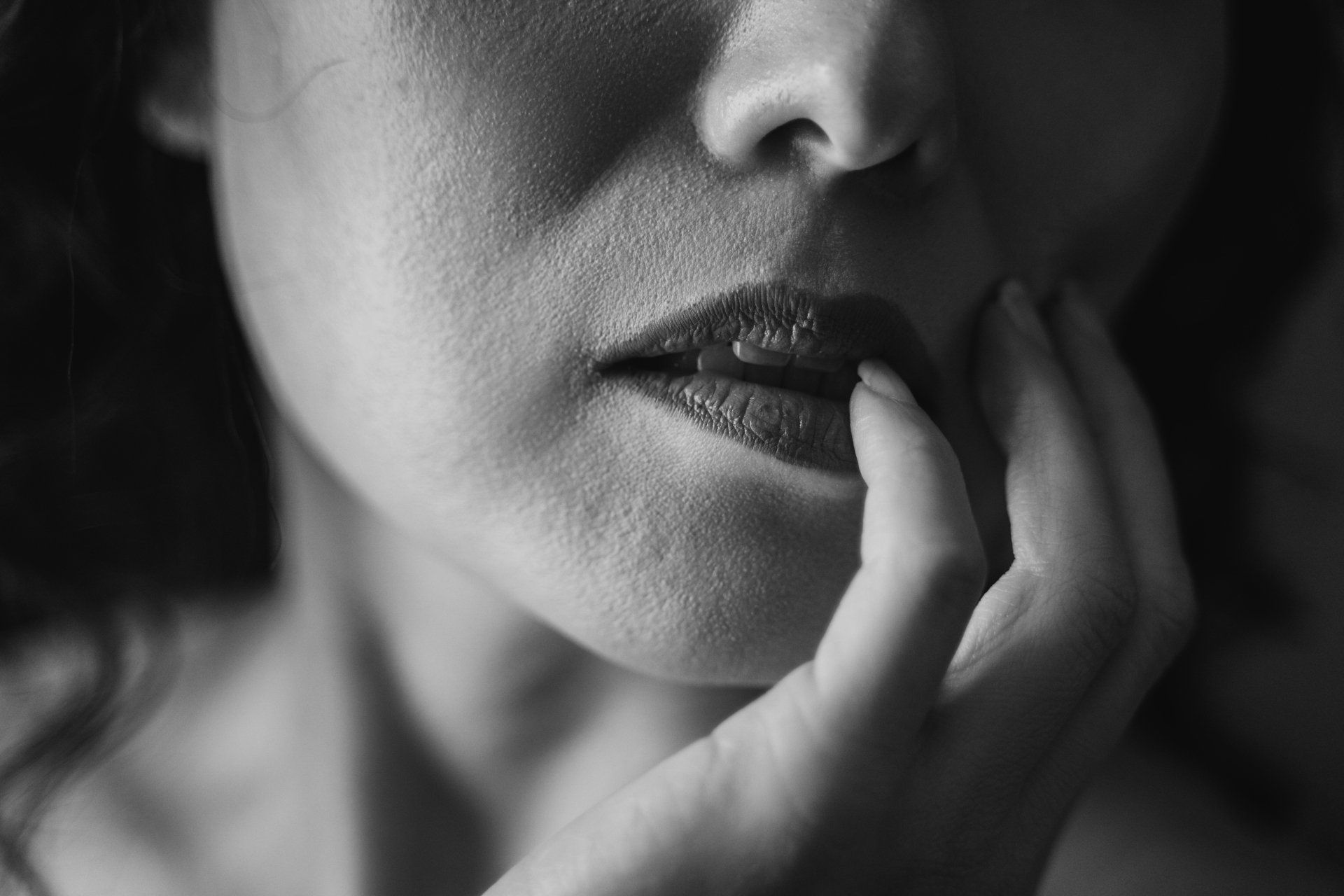 boudoir woman with fingers on lips