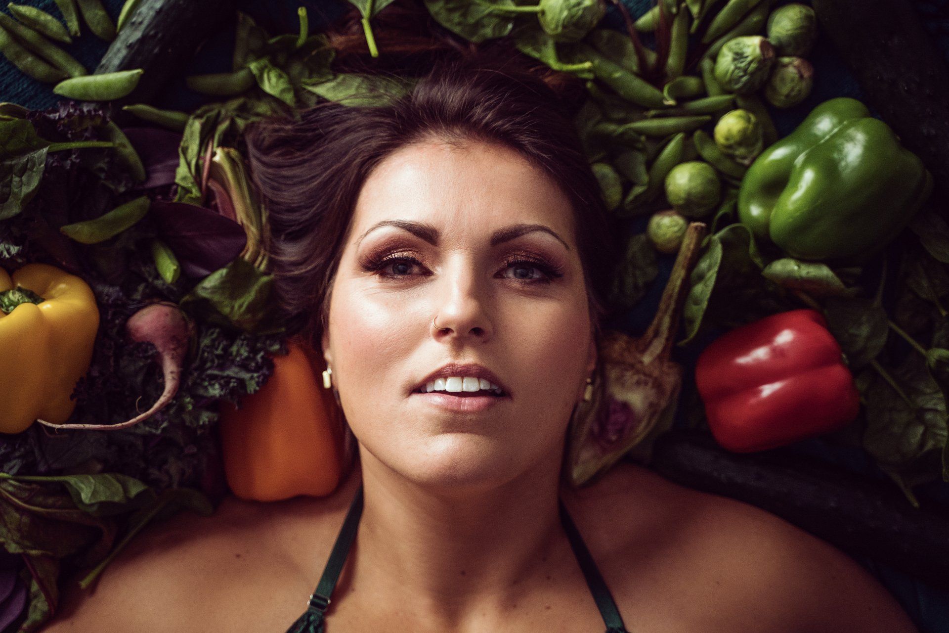 woman surrounded by vegetables