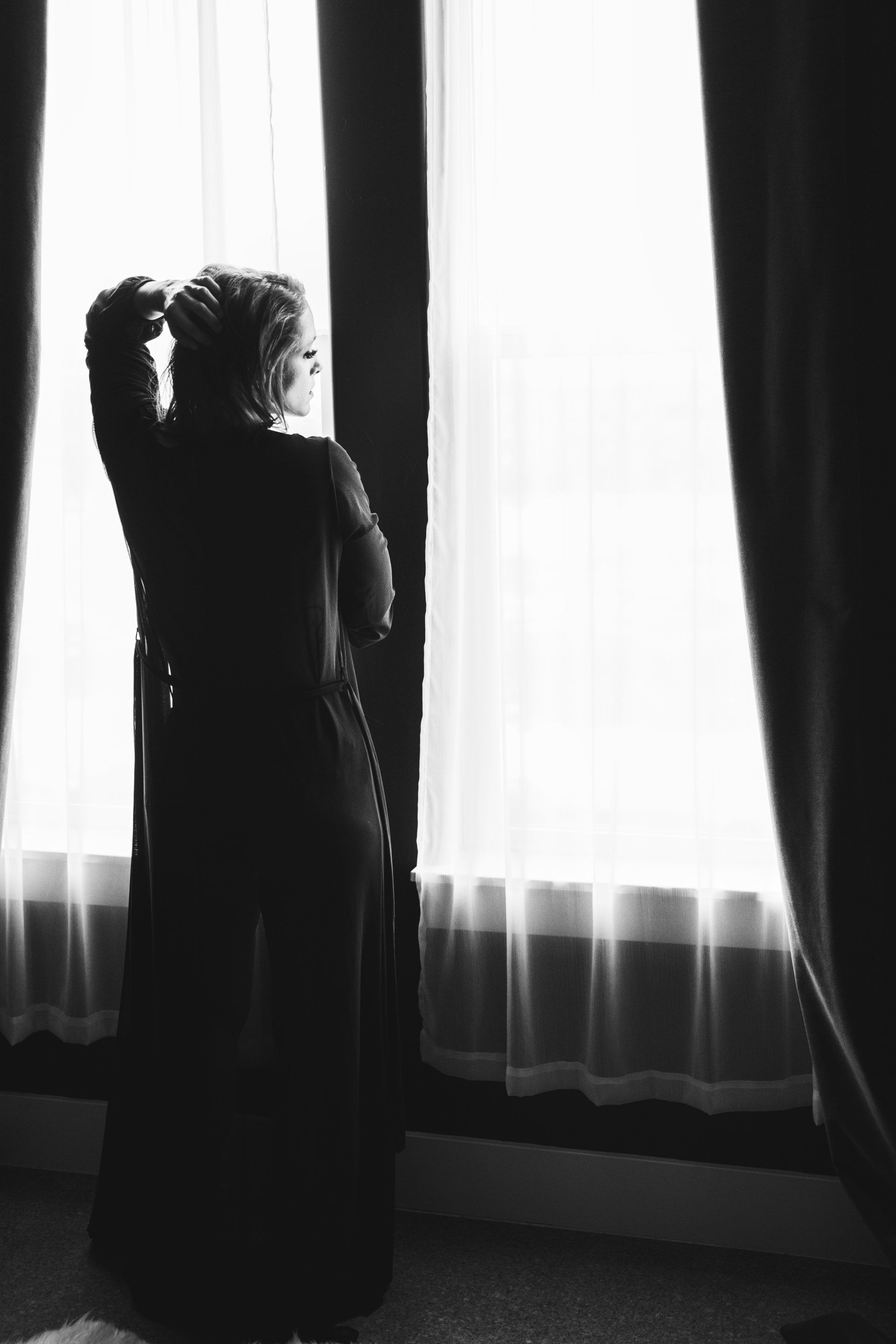 portrait of woman standing in front of window