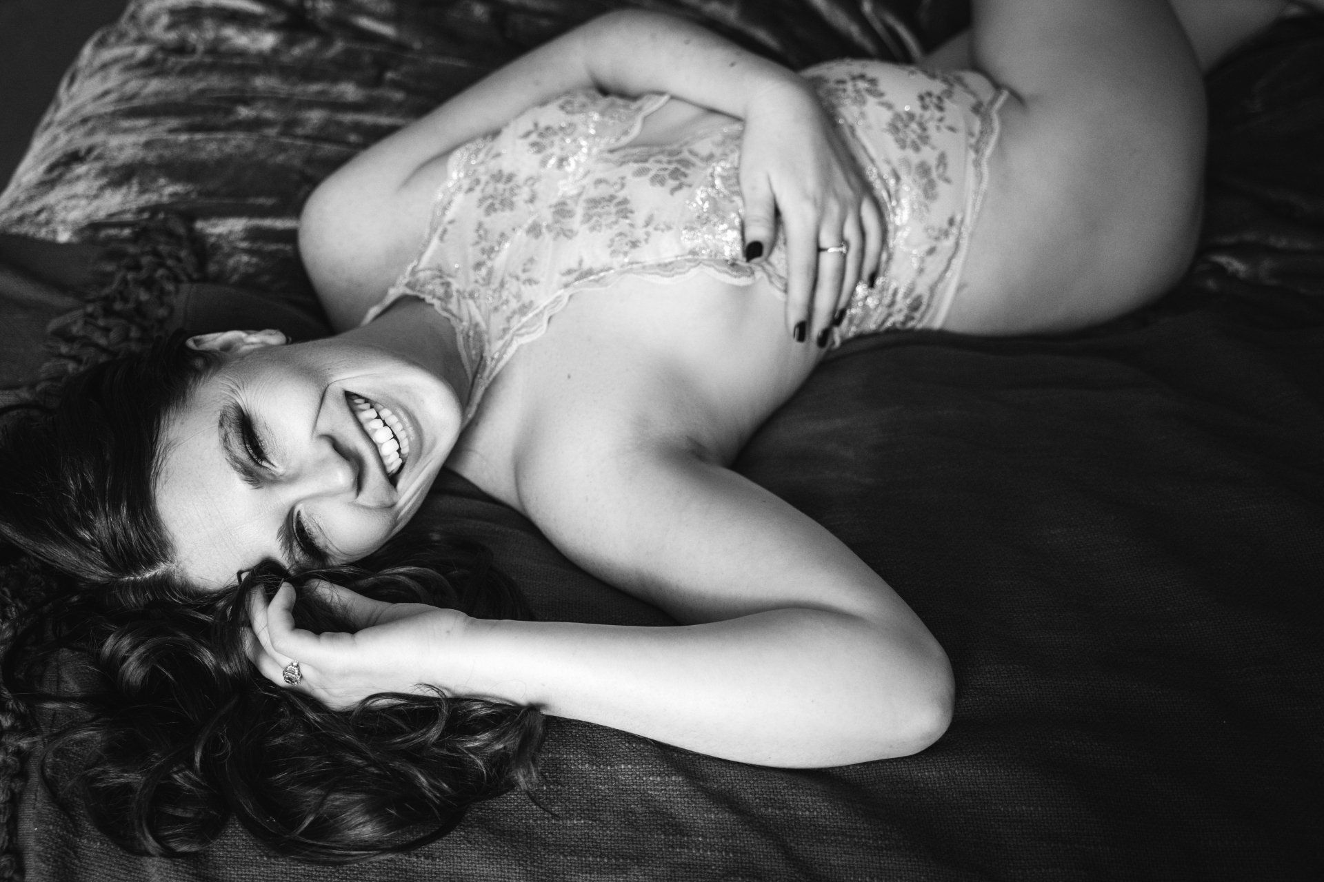 bridal boudoir woman on bed laughing
