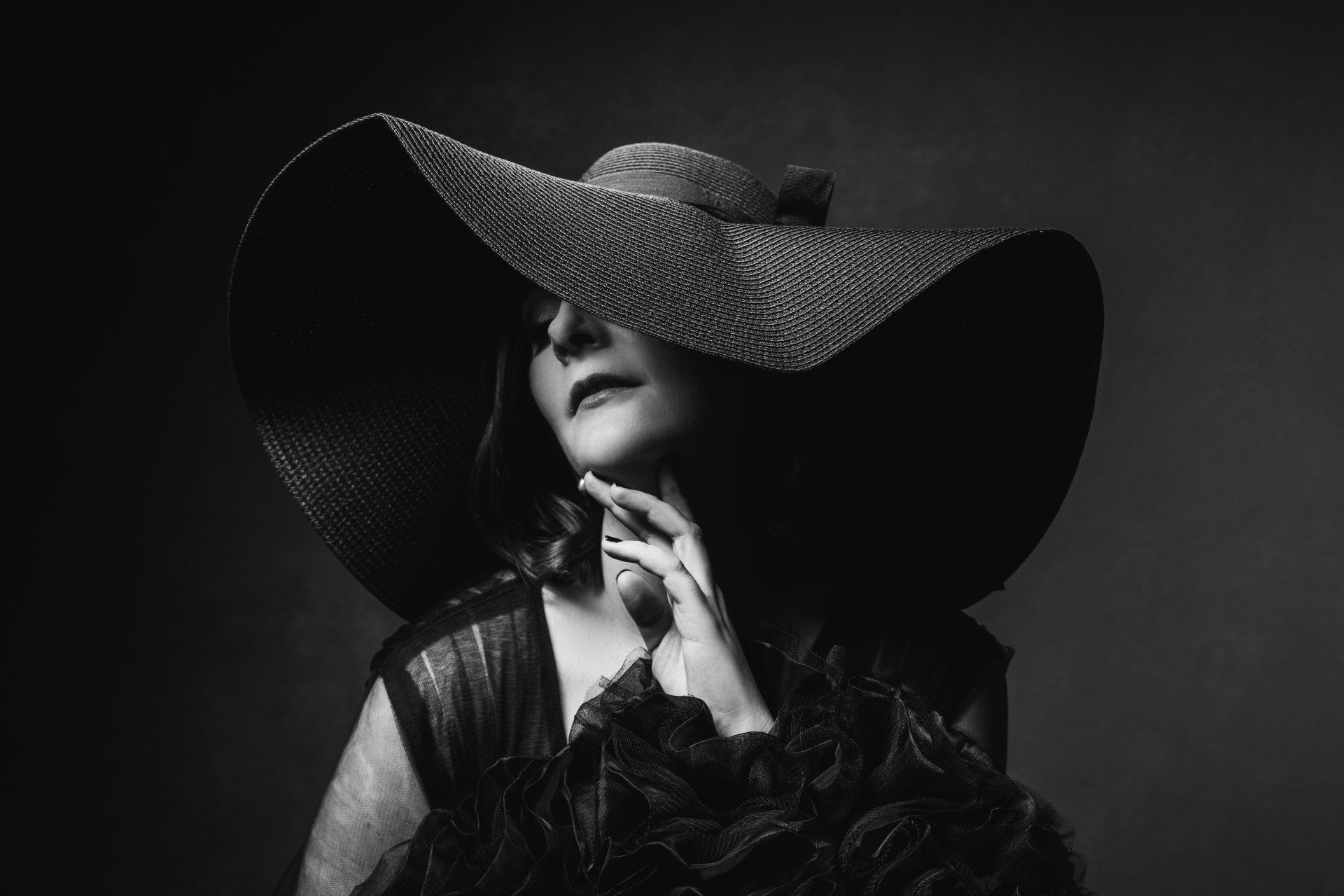 woman wearing black dress and black hat