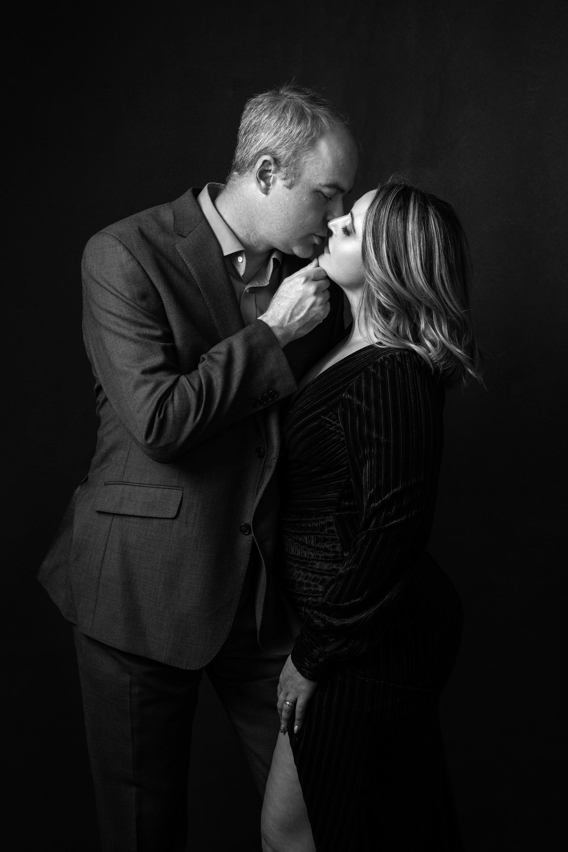 man leaning in to kiss woman
