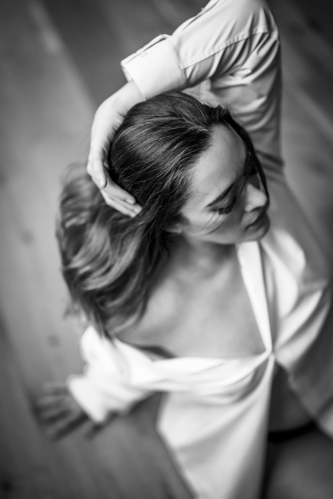A woman poses for a photo with her hair styled up, showcasing her elegant look and confident demeanor.