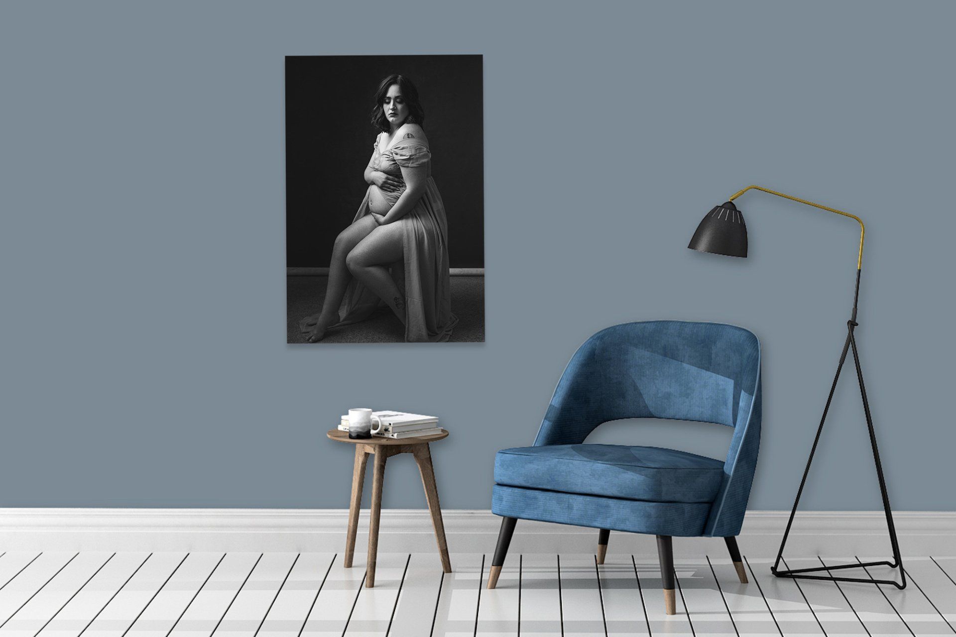 A blue chair in front of a wall with a painting.