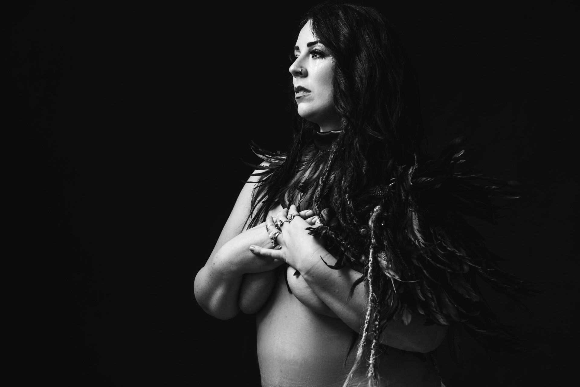 photograph of a woman wearing necklace made out of feathers