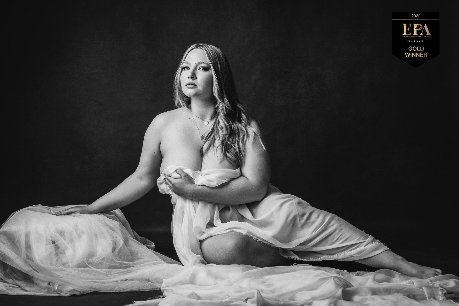 woman laying and covering herself with sheets