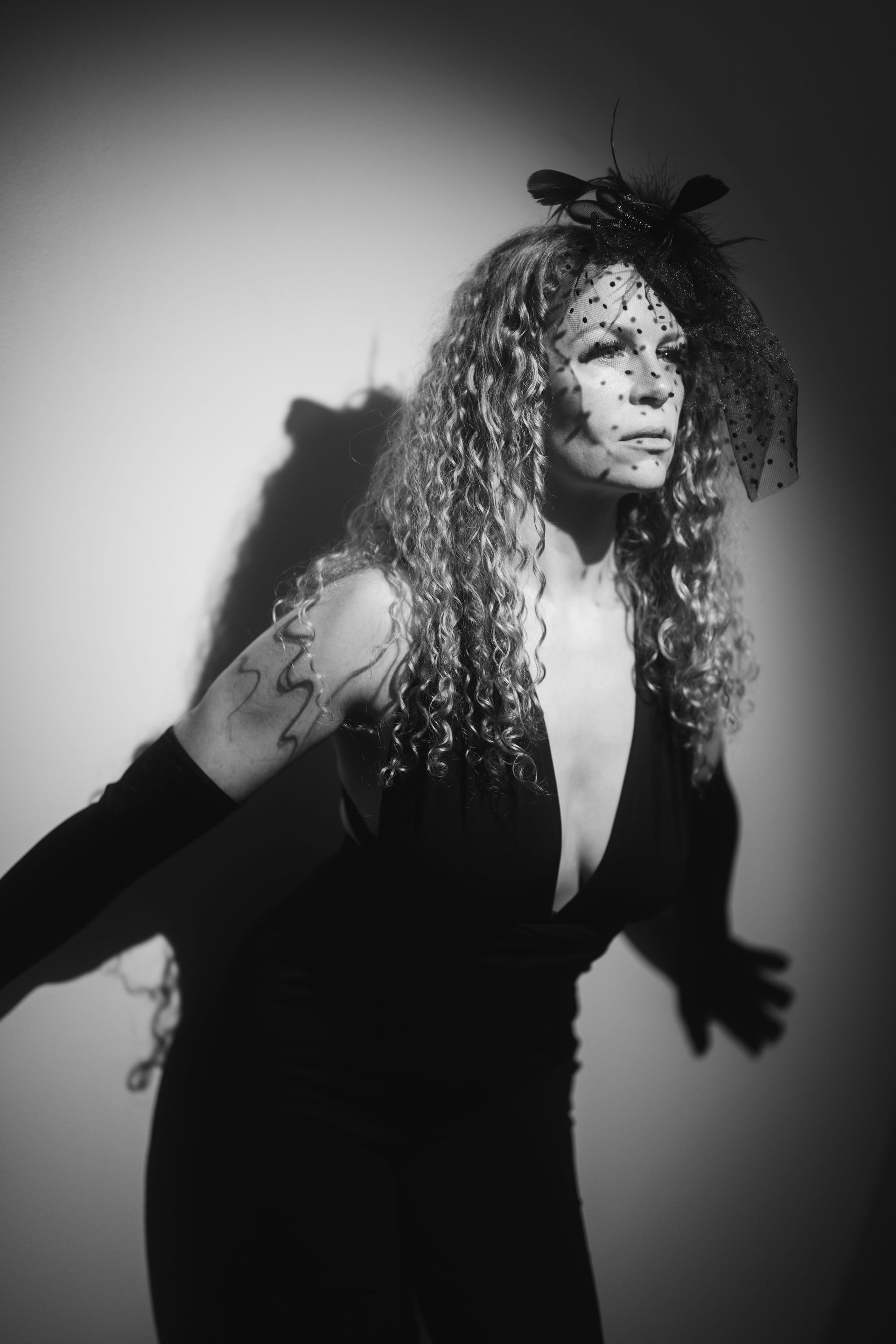 A woman with curly hair posing for boudoir photography