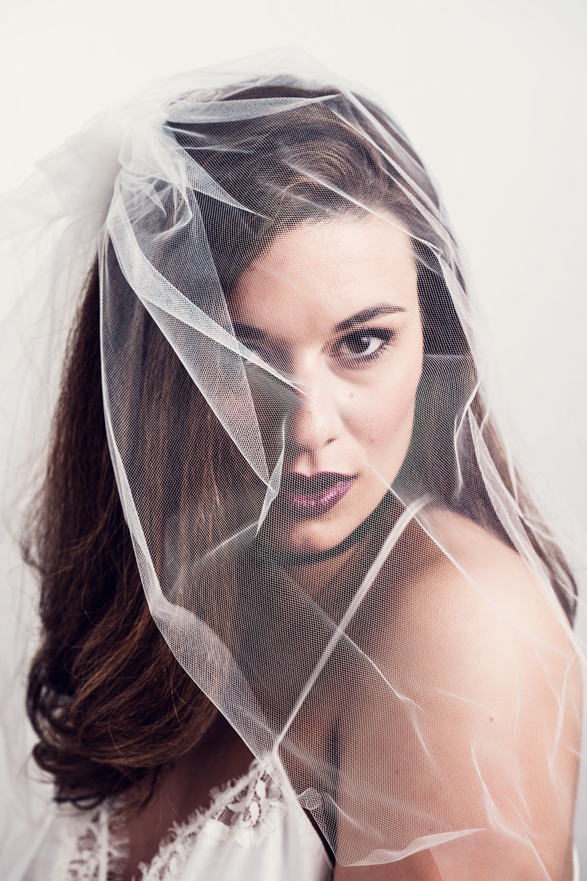 A woman wearing veil for Bridal Boudoir