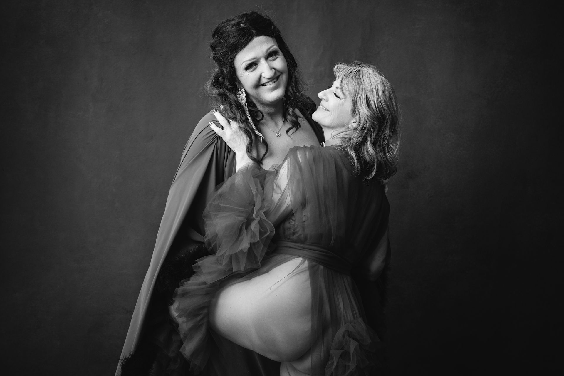 Two women standing together for a black and white portrait.